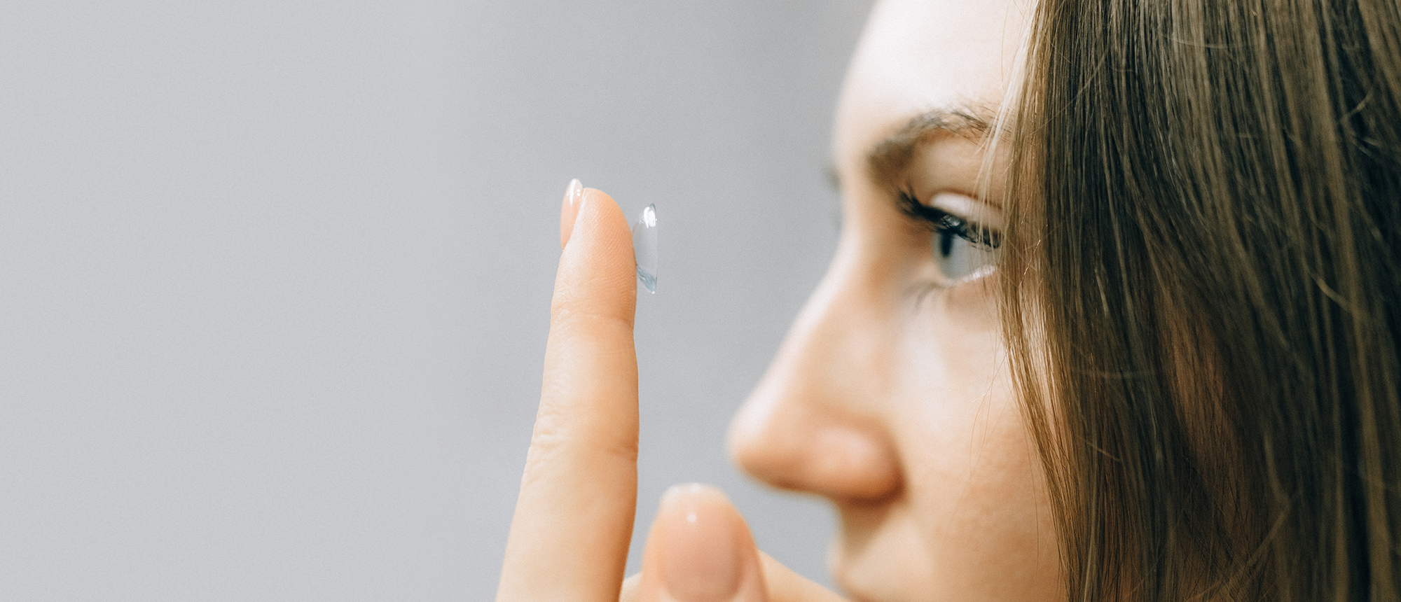 Woman looking at contact lens