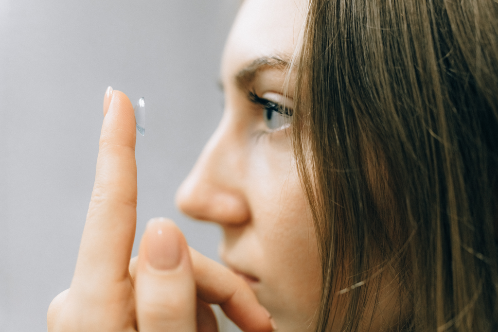 Woman looking at contact lens